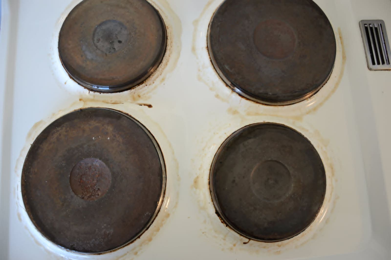 Cooktop — years of burnt-on spills lifted off — Before