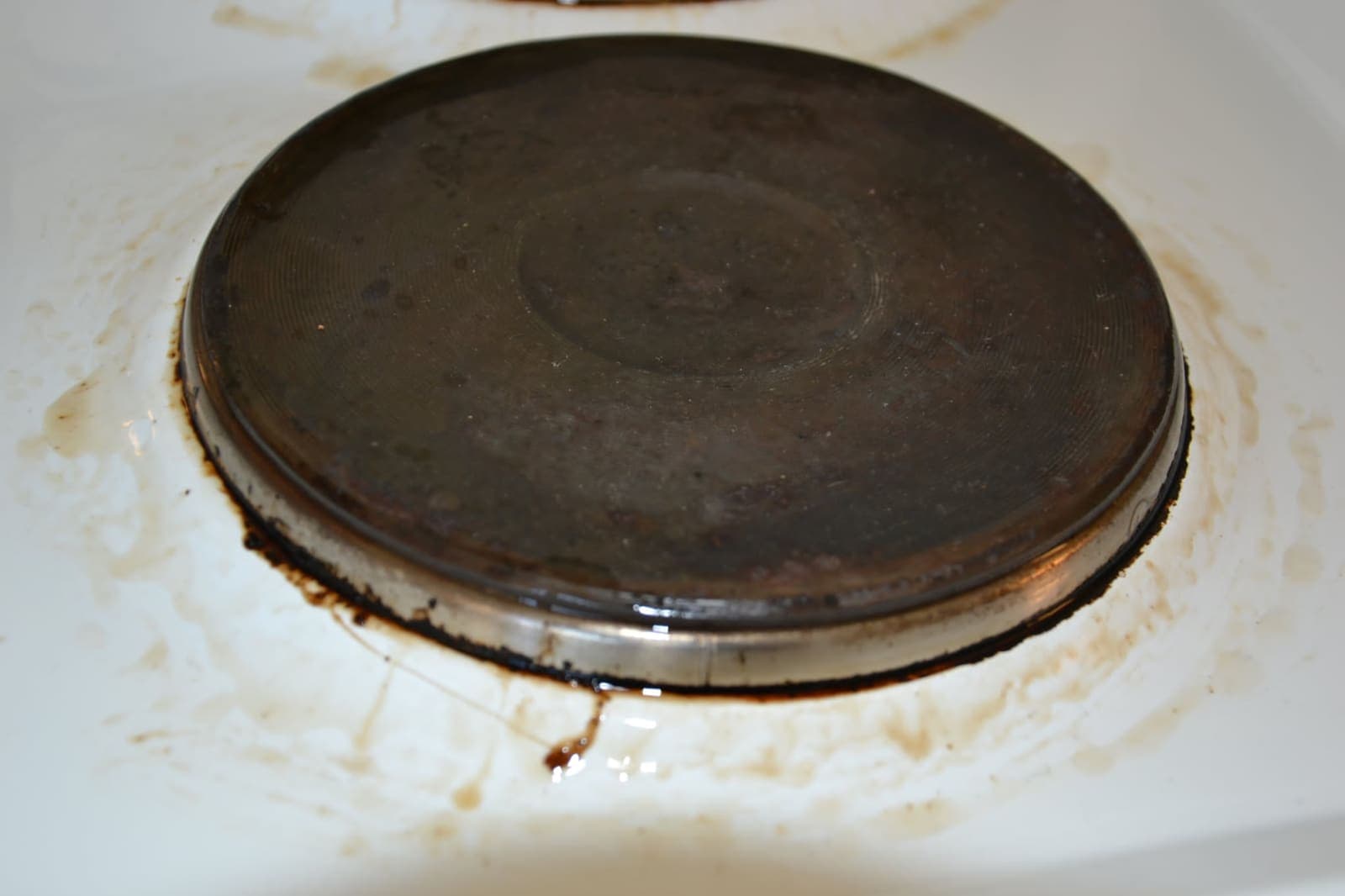 Hob plate — burnt-on grease removed — Before